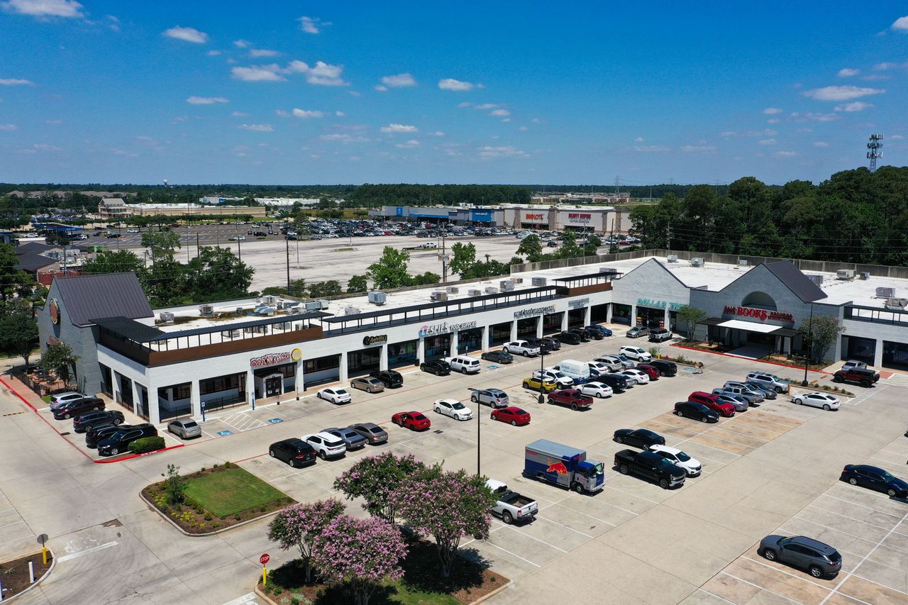 The renovated west shops at Deerbrook Shopping Center — Leslie's, Next Level Urgent Care, Dollar Tree and Half Price Books — with the second-generation restaurant endcap at left