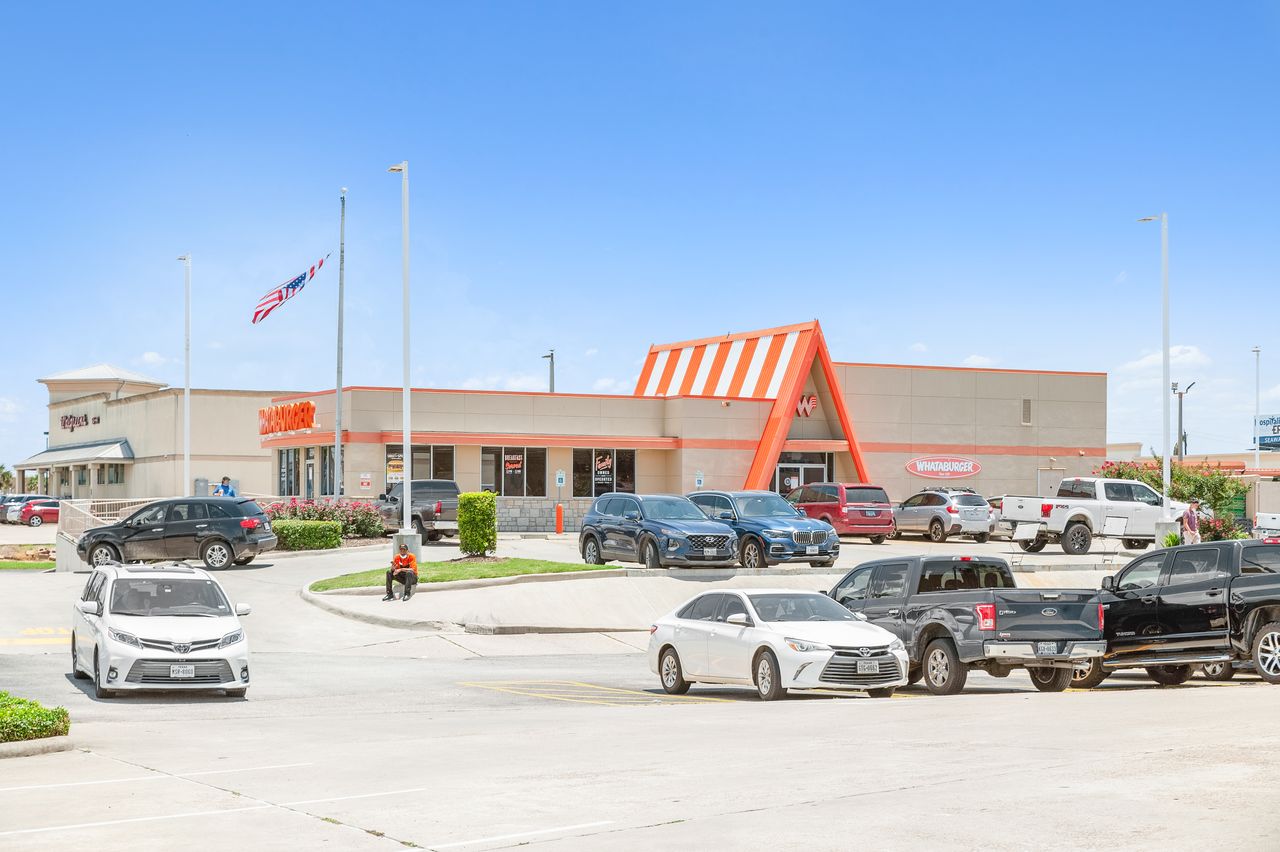 Whataburger's orange-striped A-frame pad building at The Plaza on Galveston Island's Stewart Road entrance